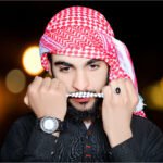 Artistic portrait of a man wearing a keffiyeh, holding a rosary, and showcasing cultural fashion.
