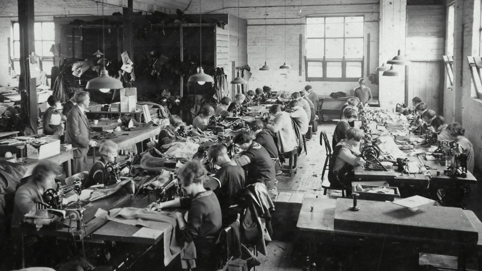 A group of workers running production on a textile mill floor, the direct-from-mill route where thobe fabric cost and specification are controlled