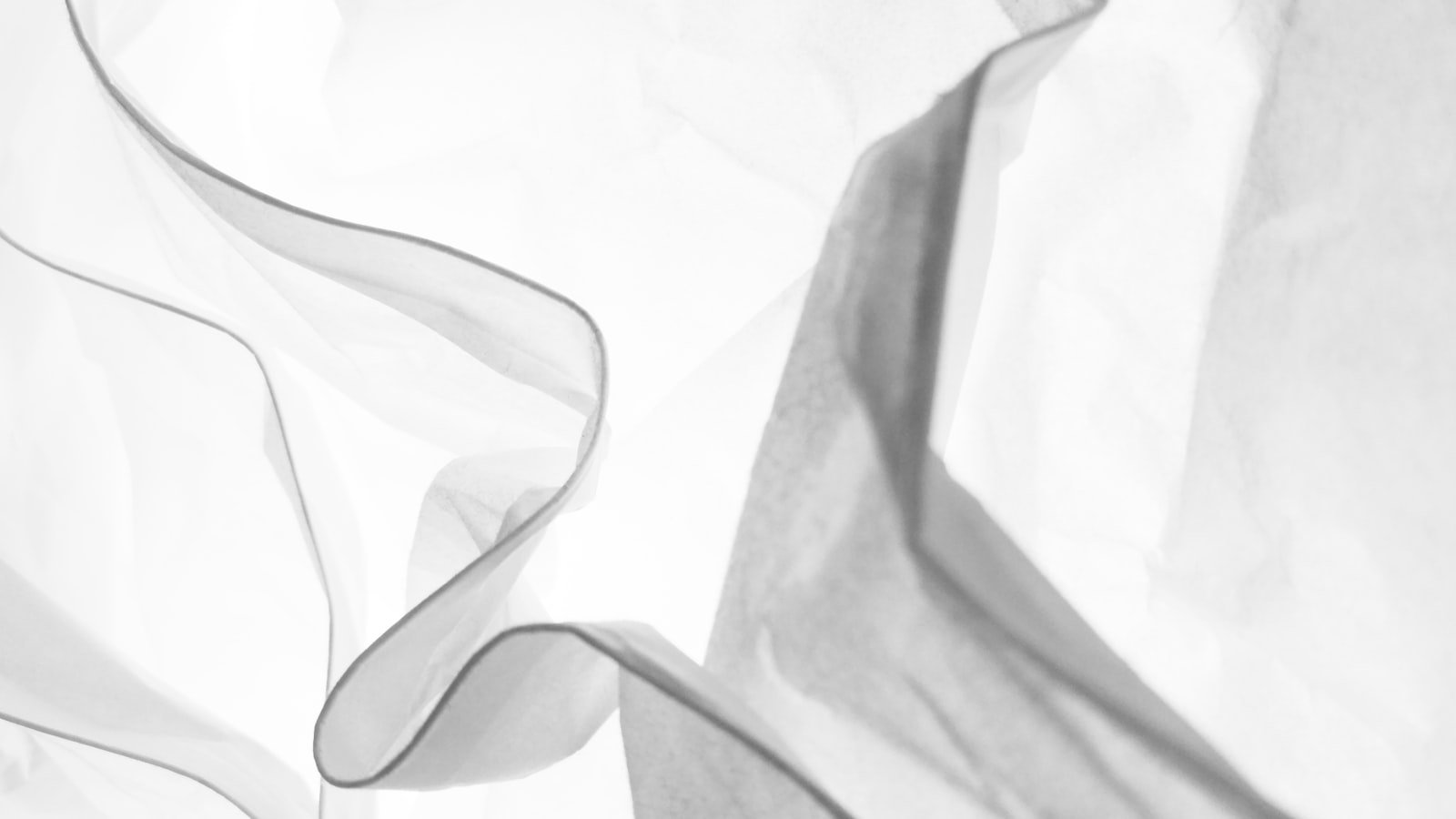 Close-up of white textile fabric layered on itself, showing the hand feel and density that GSM numbers describe in thobe fabric